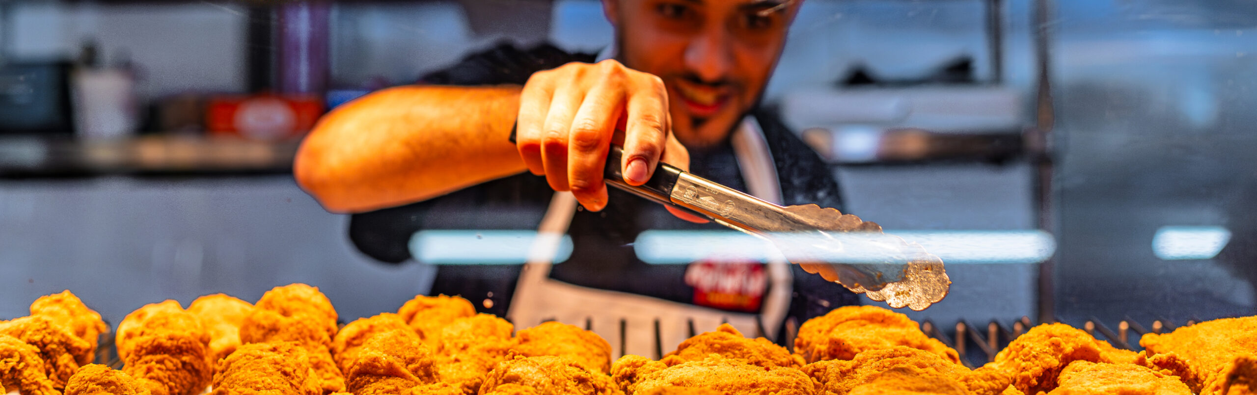 Worker serving fried chicken